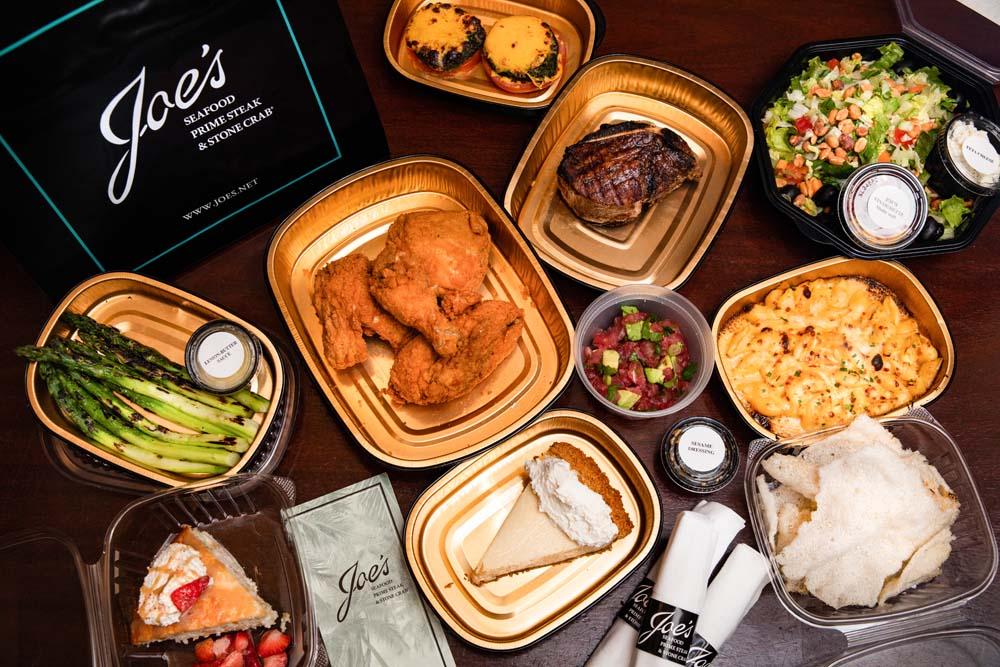 Steak, fried chicken and a variety of other dishes, in to go boxes 